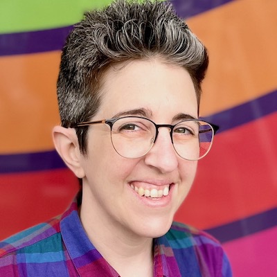 Alyssa Panetta (she/her/hers) smiling with colorful background.