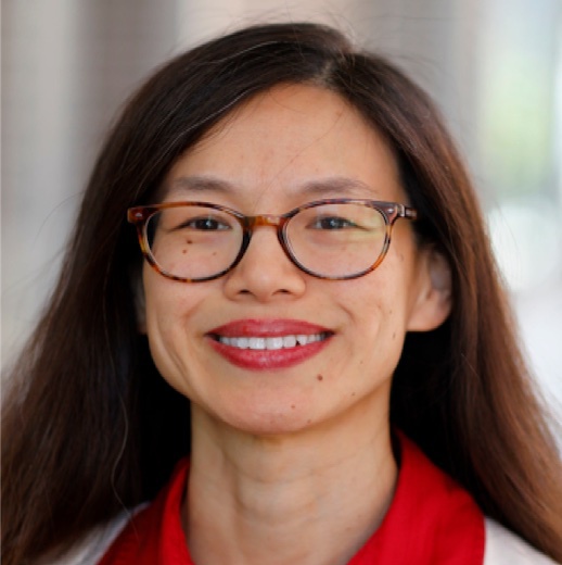 Asian woman wearing red shirt and white sweater with long hair.  Also wearing glasses.